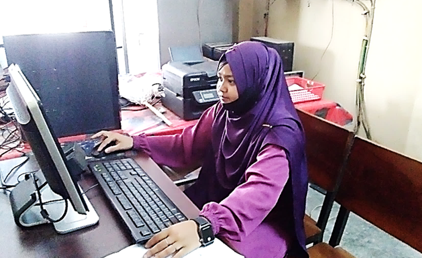 Shamsunnahar on a computer.