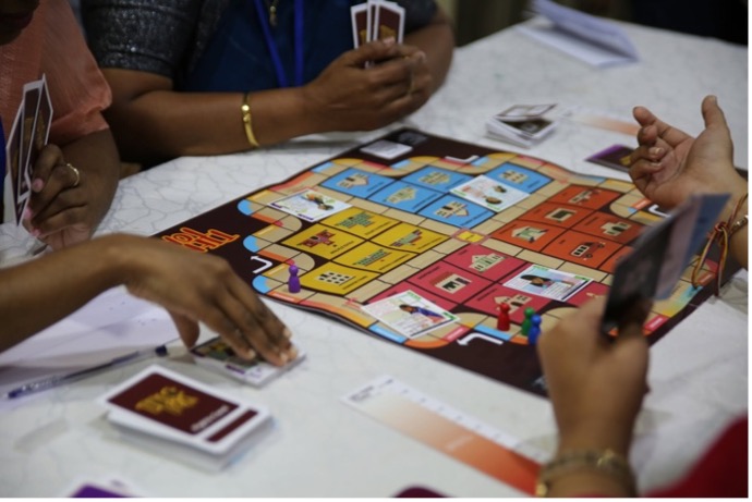 Women and girls playing Tiene Toa.